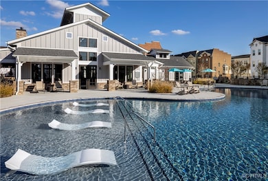 View of pool with a hot tub and a patio area