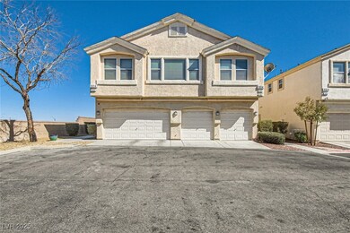 View of property with an attached garage and stucc