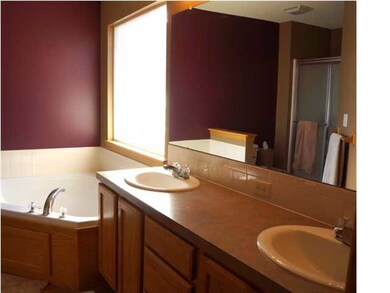 Master bathroom with separate tub and shower.