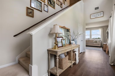 Stairway with baseboards, a towering ceiling, and