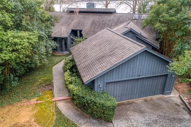 Home is nestled in mature landscaping