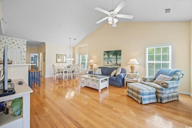 Living room with ceiling fan, high vaulted ceiling