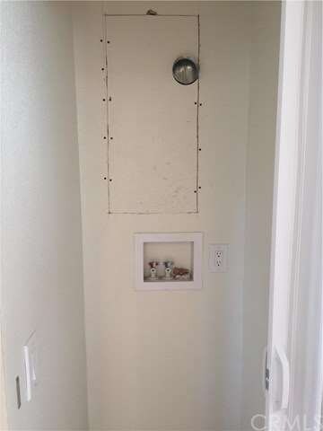 Stackable washer and dryer hookup in the hallway.