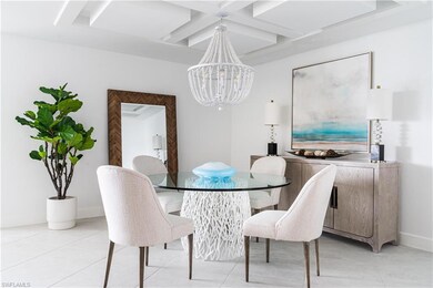 Dining area featuring coffered ceiling, a chandelier, light tile patterned floors, and beamed ceiling
