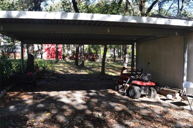 View of parking / parking lot with a carport