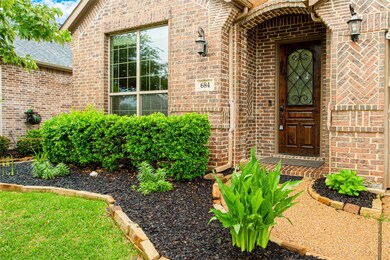 Doorway to property with brick siding and roof with shingles