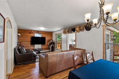 Living room featuring baseboard heating, an inviti