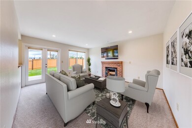 Large family room features a wood burning fireplace and has new French doors that lead you out to the large, entertainment-sized deck and yard. New windows throughout.