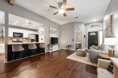 Living room with dark wood finished floors, ceili