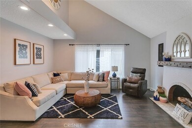 Fantastic view of living room, vaulted ceiling and stunning fireplace