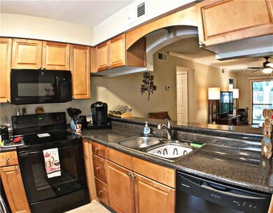 Kitchen with solid surface counters  and wood cabi