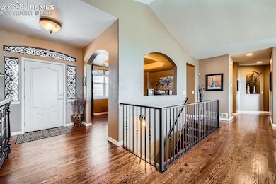 Entryway featuring vaulted ceiling and hardwood / wood-style floors