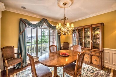 The formal dining room boasting hardwood floors is
