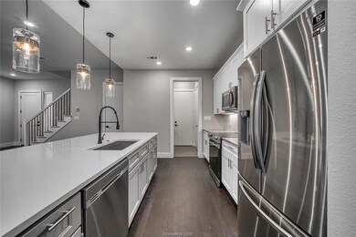 Kitchen featuring a sink, dark wood finished floor