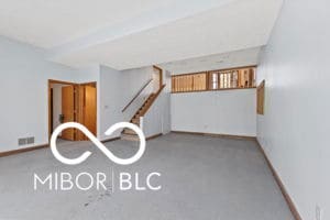 unfurnished room with baseboards