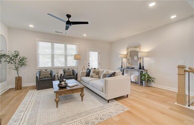 Living room featuring light hardwood / wood-style floors and ceiling fan