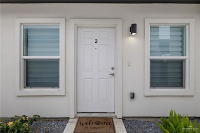 Property entrance with stucco siding