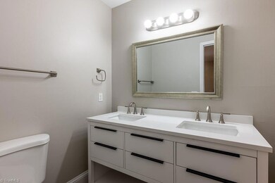 Primary Bathroom: Features include LVP flooring for easy cleaning, fresh new paint, bright new double sink vanity and new fixtures.