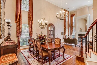 Formal dining with soaring ceilings and windows