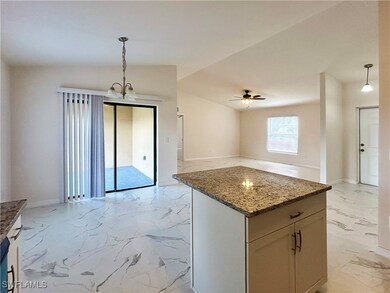 Kitchen with ceiling fan with notable chandelier,
