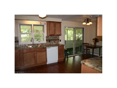Kitchen has double windows above the sink and pati