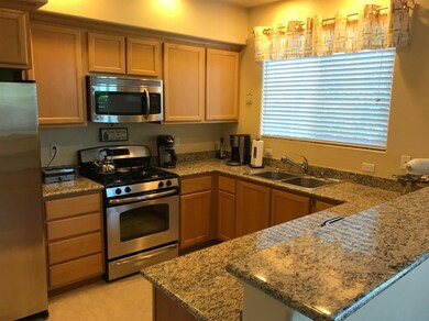 The kitchen boasts stainless appliances and granit