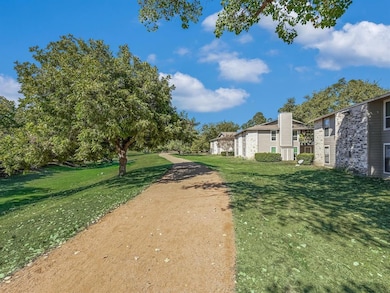 View of home's community with a lawn