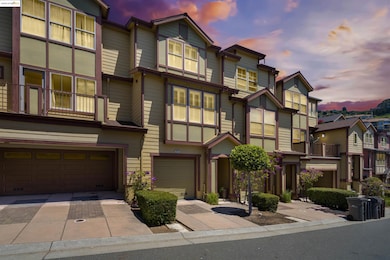 View of front of property with a residential view, driveway, and a garage