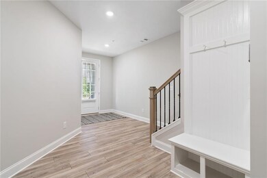 Terrace level entry from the garage with a view to the front door. Plenty of storage with the bench and hooks and utility closet.