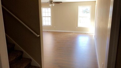 Entryway into living room w/view of stairs to bonus room