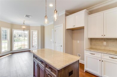 Island in kitchen provides great workspace.