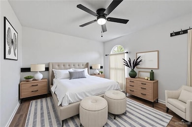 Bedroom with wood finished floors, baseboards, and a ceiling fan