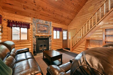 The log walls and plank ceiling create a warm ambiance.