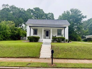 Bungalow featuring a front yard and a porch