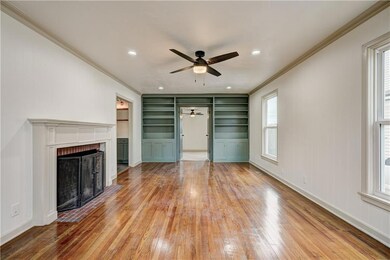 Spacious living room with hardwood floors and buil