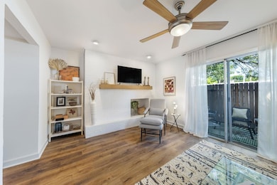 Living area featuring a ceiling fan, baseboards, 