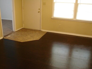 Tile entryway with hardwood floors