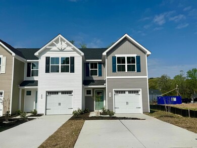 View of front facade with driveway, an attached ga