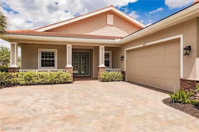 View of front of home with a porch, an oversized g