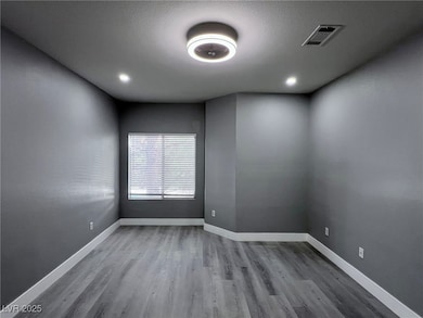 Unfurnished room with light wood-style floors and a textured ceiling