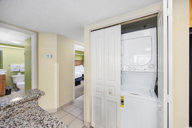 Clothes washing area with light tile patterned flo