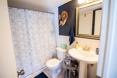 Bathroom featuring tile patterned flooring, curta