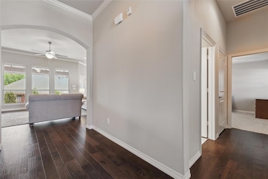 Hallway featuring dark wood finished floors, arche