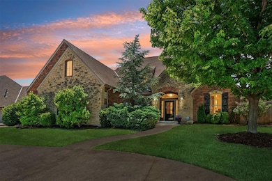 Tudor house with a front yard, brick siding, stone siding, and roof with shingles