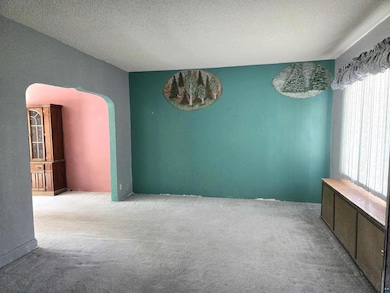 Carpeted empty room featuring a textured ceiling