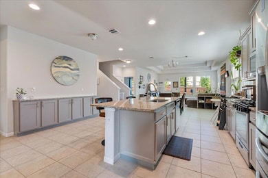 Kitchen with visible vents, a sink, a kitchen isl