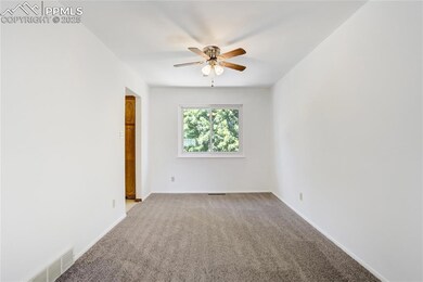 Empty room with light carpet and ceiling fan