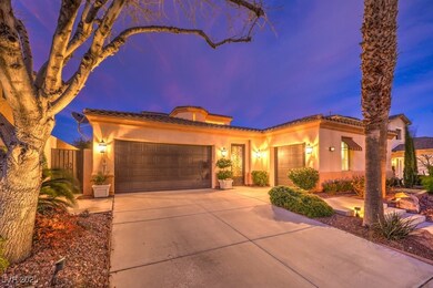 Mediterranean / spanish-style home featuring a gar
