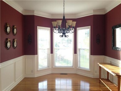 Nice dining room with wainscoting on the walls and a great bay window.