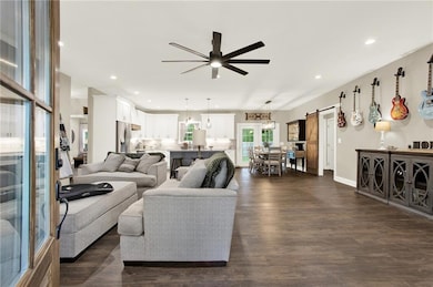 Living room featuring a barn door, dark wood-type 